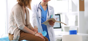 Doctor,And,Patient,Discussing,Something,While,Sitting,At,The,Table